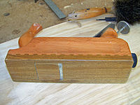 A hand plane with a lignum vitae sole, likely Bulnesia, and a pearwood body