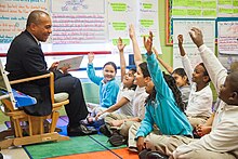 Patrick reading a book to schoolchildren in 2011 Match-community-day-school 5541078470 o.jpg