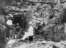 Bergleute außerhalb eines Minenschachts am Mount Victoria in der Nähe des Mount Morgan um 1892.jpg