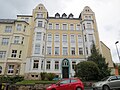 Apartment building in half-open development with a front garden and enclosure wall