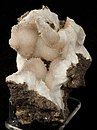 Natrolite in spherical clusters inside protective pocket of volcanic rock