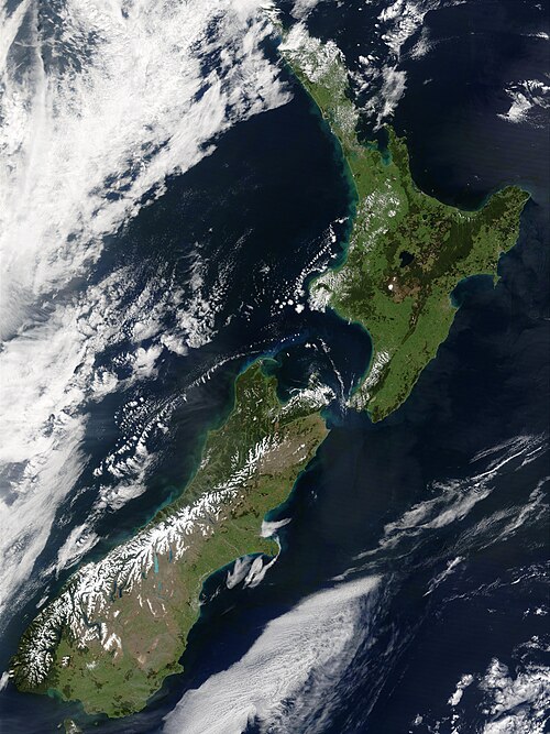 The snow-capped Southern Alps dominate the South Island, while the North Island's Northland Peninsula stretches towards the subtropics.