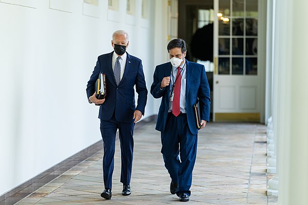 President Joe Biden walks with Chief of Staff Ron Klain along the Colonnade of the White House.