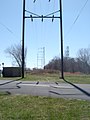 Abandoned K&T Branch, Behind Frankford Arsenal, 2006 Note rails disappearing into roadway for river access point.