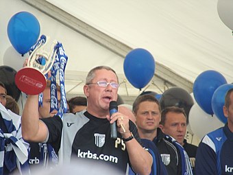 Paul Scally (holding trophy) has been the club's chairman since 1995.