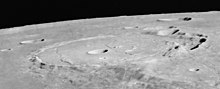 Oblique view of Posidonius from Apollo 17. Note that the lava which flooded the crater reached its rim and is clearly above the mare plain to the west (left). Posidonius crater AS17-M-0938.jpg