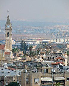 Vedere a orașului din Turnul Alb spre est, către centrul orașului. În stânga se vede clopotnița bisericii Coborării de pe Cruce din Mănăstirea Sfântul Nicodim, iar în spate -Uzinele Nesher Ramla, centrul Ayalon de epurare a apelor și Munții Binyamin
