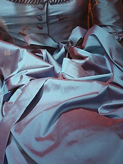 Shot silk Fabric with warp and weft in two different colors, producing a changeable effect; most often a plain-woven silk or synthetic