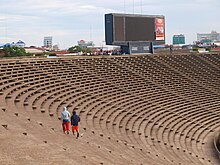 Phnom Penh Olympic Stadium, one of the shooting locations Seats in Phnom Penh Olympic Stadium (14562683674).jpg