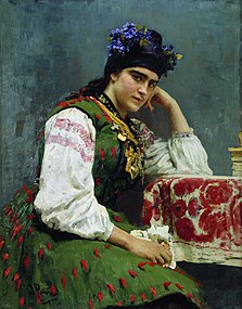 Portrait d'une femme assise, aux habits colorés.