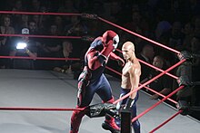 Suicide (portrayed by Kazarian) posing above Daniels, who once used the gimmick. Suicide TNA.jpg