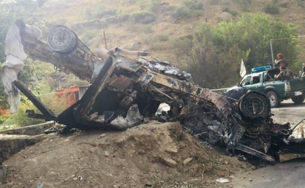 Taliban forces move past a destroyed vehicle in the Panjshir Valley, 12 September 2021