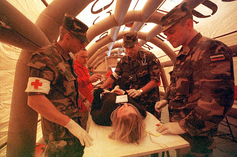 File:US Navy 020629-N-1337M-003 Medics Treat Survivors.jpg