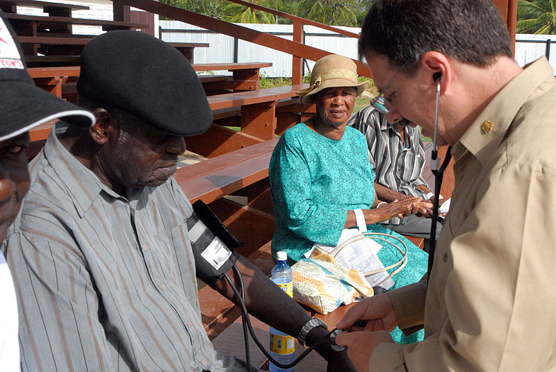 File:US Navy 070930-N-9562H-015 U.S. Public Health Service Capt. Steve Savoia, attached to Military Sealift Command hospital ship USNS Comfort (T-AH 20), checks the vital signs of a patient at the Mahaicony Community Centre.jpg