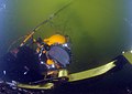 Army Sgt. Chaise Turner, assigned to the 544th Engineering Dive Team of Fort Eustis, Virginia, operates a cargo strap that is attached to the sunken former Soviet submarine Juliett 484