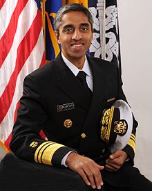 Vivek Murthy seated facing a microphone with an audience behind him