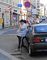 Woman leaning against car in Linz, Austria.jpg