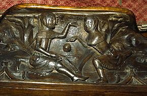 Youths playing ball, carved on a misericord at Gloucester Cathedral. Youths playing ball Gloucester Cathedral.jpg
