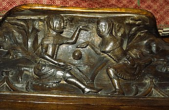 Wood carving of two youths playing ball on a misericord at Gloucester Cathedral, c. 1350.