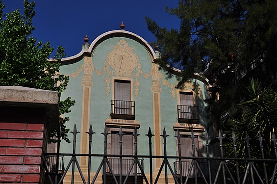 Building with a unique frozen clock, probably showing the date?, on a building near Park Guell, Barcelona, Spain