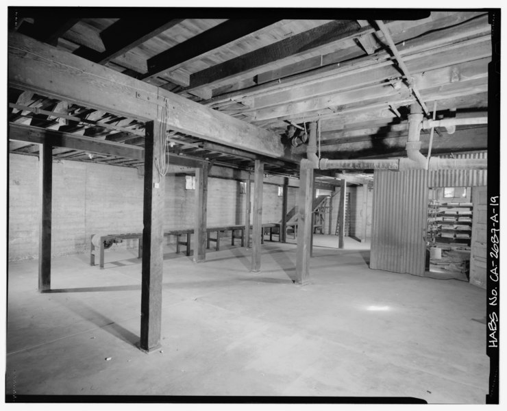 File:Bunkhouse basement interior showing storage area and a conveyor belt (circa 1936) used to unload dry goods into the basement through an opening on the east side of the bunkhouse HABS CAL,56-FILM,1A-19.tif