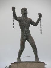 Statue of Bussa, who led the largest slave rebellion in Barbadian history. Bussa statue.png