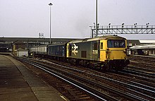 A British Rail Class 73 with a parcels van and carriages under British Rail carrying the mail in 1986 through Clapham Junction. Clapham Junction - geograph.org.uk - 581730.jpg