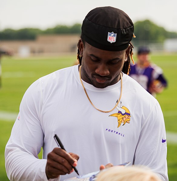 Patterson signing autographs during training camp in 2014