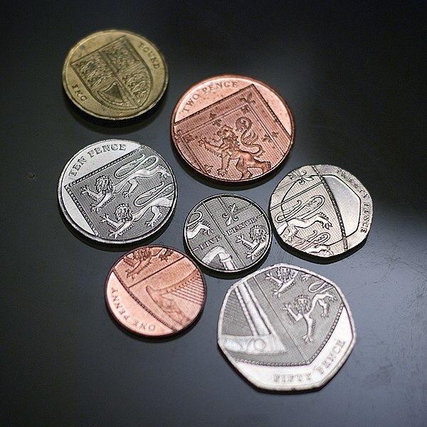 The Royal Shield formed by six UK coins, with the £1 coin depicting the whole of the shield.