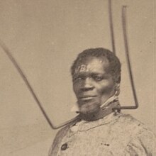 Wilson Chinn was enslaved by Volsey B. Marmillion (recte Valsin B. Marmillion), who made a standard practice of branding his slaves on the face with his initials, V.B.M. Detail of Wilson Chinn photograph "VBM".jpg