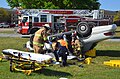 Emergency service personnel remove one of the simulated casualties from a motor vehicle accident.jpg