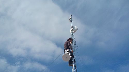 A volunteer installing a "supernode" of guifi.net. In July 2018 guifi.net had over 35,000 active nodes and about 63,000 km of wireless links.[10]