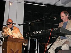 Perrey playing a Ondioline and Countryman playing a Roland synthesizer