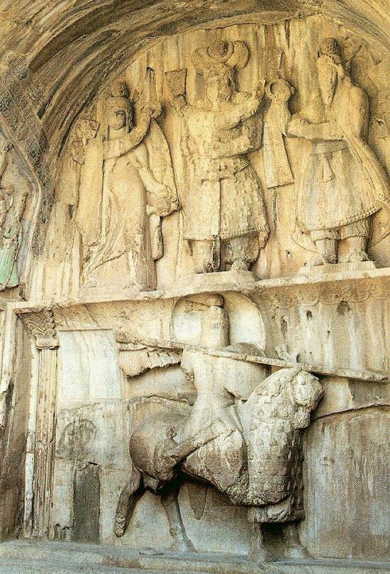 Khosrow Parviz is standing here. On his left is Ahura Mazda, on his right is Anahita, and below is, Khosrau dressed as a mounted Persian knight riding