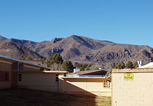 Los Alamos High School sits below the Jemez Mountains, as seen before the three-story building replaced A-D wings LAHS Mountains.jpg