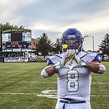 Noah displays his charger bolts gloves