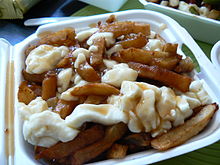 Poutine, a Canadian dish of fried potatoes, cheese curds, and gravy