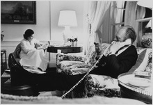 U.S. President Gerald Ford on the phone Photograph of First Lady Betty Ford Reading a Newspaper, while President Ford Talks on the Telephone, in the Second... - NARA - 186793.tif