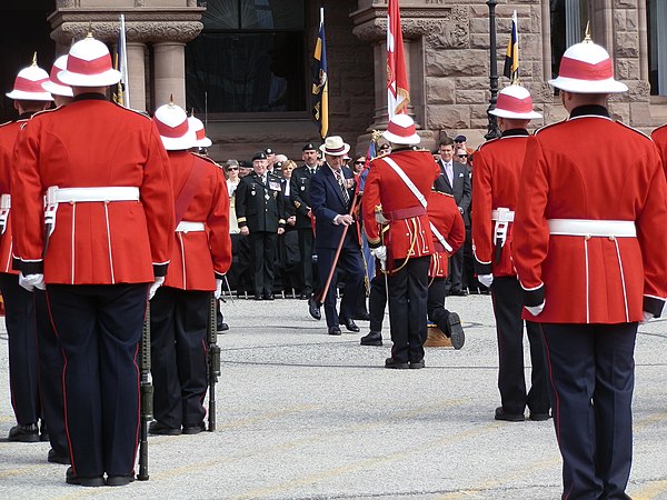 Members of the Royal Canadian Regiment in full dress. The Canadian Army's universal full dress includes a scarlet tunic, midnight blue trousers, and a