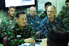 Vice Admiral Kim Jung-du, commander for the Republic of Korea Navy salvage efforts, and Rear Admiral Richard Landolt, on scene commander of U.S. support to South Korean salvage efforts, discuss salvage operations aboard the ROKS Dokdo ROKS Cheonan salvage meeting.jpg