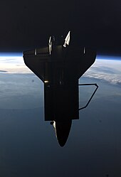Atlantis seen from the Space Station after undocking. STS135 view Shuttle Atlantis flyaround of ISS.jpg