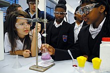 A titration is demonstrated to secondary school students. School level titration demonstration.jpg