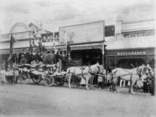 Outside the Stock Exchange in 1900 StateLibQld 1 90348 Float of the Charters Towers Stock Exchange, 23 May 1900.jpg