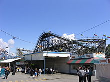 Stalls used to house the carnival games at Playland. The Wooden Roller Coaster is visible behind the stalls. TheCoasterPlayland.JPG