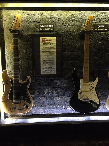 Queen guitar (right, next to a Rolling Stones guitar) at the Cavern Club in Liverpool, marking a 31 October 1970 Queen concert at the venue