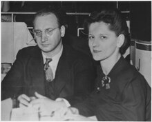 A man and woman in formal dress sat at a table