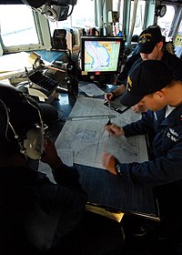 USS McFaul (DDG 74) personnel using electronic systems and a navigation chart while she transits through the Turkish Straits US Navy 080822-N-4044H-060 Quartermaster 2nd Class Carlos Oqendo plots points on the navigation chart aboard the guided-missile destroyer USS McFaul (DDG 74).jpg