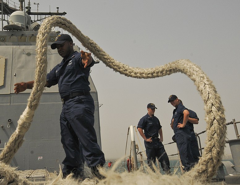 File:US Navy 110701-N-YM590-028 Cryptologic Technician (Technical) 2nd Class Darius Allison, left, tosses a mooring line onto the deck of the guided-mis.jpg