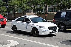 US Postal Police Ford Police Interceptor Sedan, responding with red and blue lights US Postal Police Ford Interceptor Sedan (28362064841).jpg