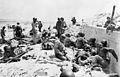 The US 1st Army: Casualties of 4th US Infantry Division, attended by US Medical Corpsmen, await evacuation by the sea wall at 'Uncle Red' Beach, UTAH Area, on the morning of 6 June. The landings on UTAH were undertaken by the 7th US Corps under Lt General Collins, the assault being carried out by the 4th Infantry Division. The invaders met little resistance and by the end of the day, 23,350 men had come ashore with less than 200 killed
